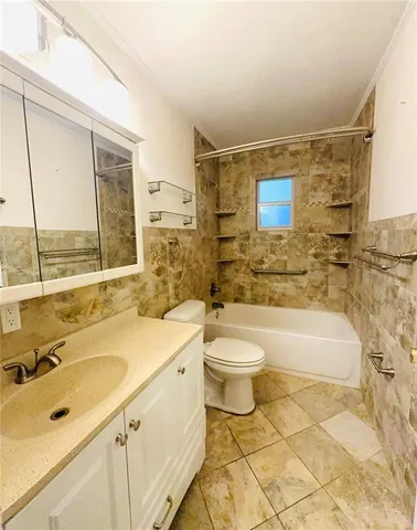a bathroom with a sink mirror toilet and bathtub