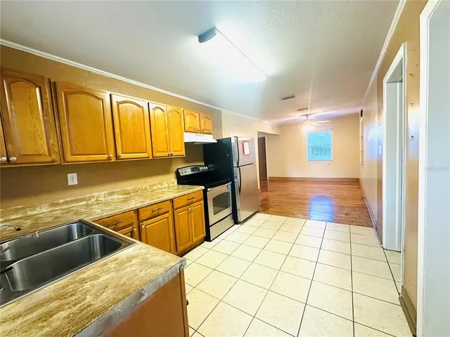 a kitchen with a sink and large window