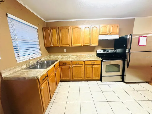 a kitchen with a stove sink and cabinets