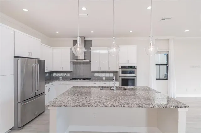 a kitchen with a refrigerator sink and microwave