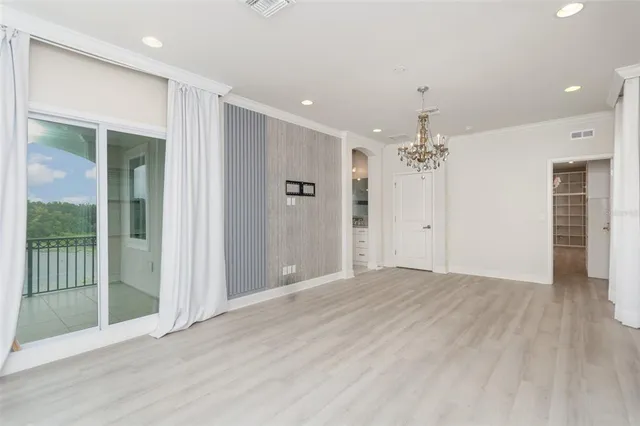 an empty room with wooden floor and mirror