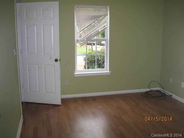 356 Sleepy Hollow Road Charlotte, NC 28217 - Photo 4 of 6 an empty room with wooden floor and windows