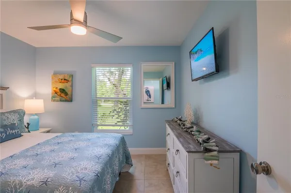 a bedroom with a bed and a painting on the wall