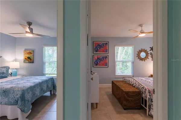 a bedroom with a bed and a painting on the wall