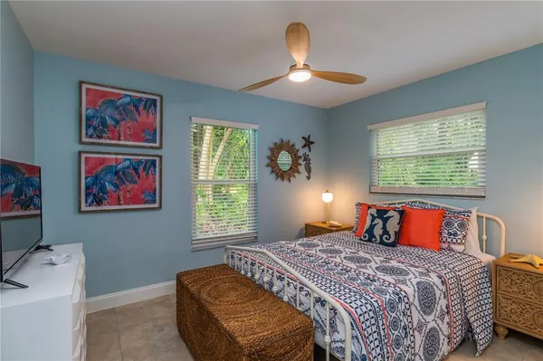 a en suite bathroom with a granite countertop sink and a mirror