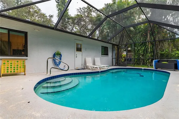 a view of a swimming pool with a yard