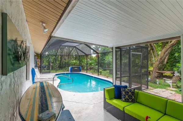 a swimming pool with outdoor seating and yard