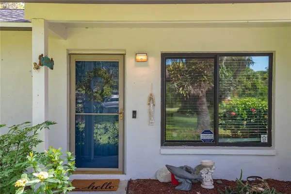 a living room with furniture a large window and a flat screen tv