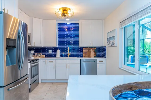 a kitchen with cabinets and stainless steel appliances