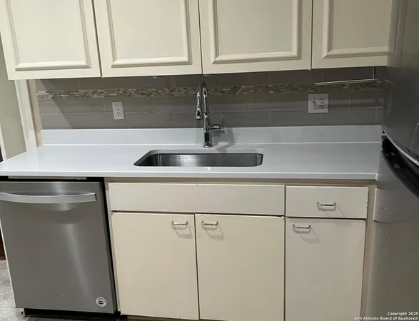 a kitchen with a sink and cabinets