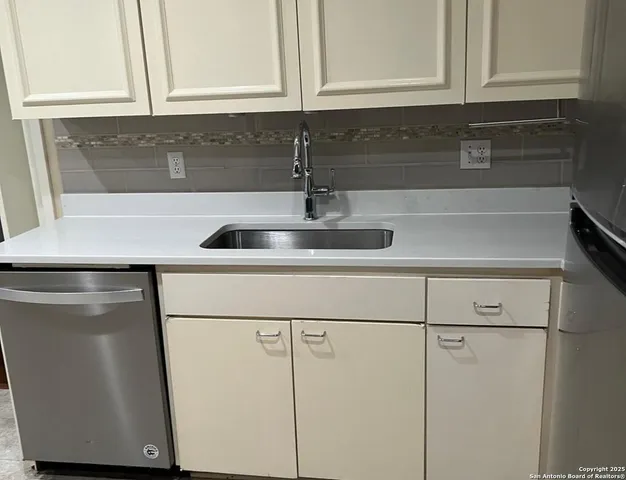 a kitchen with a sink and cabinets