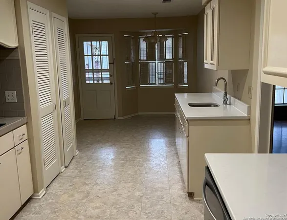 a view of a kitchen with a sink dishwasher and a refrigerator
