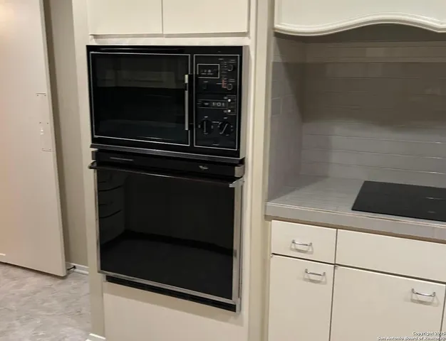 a kitchen with a stove and a microwave