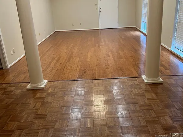 a view of a refrigerator in wooden floor