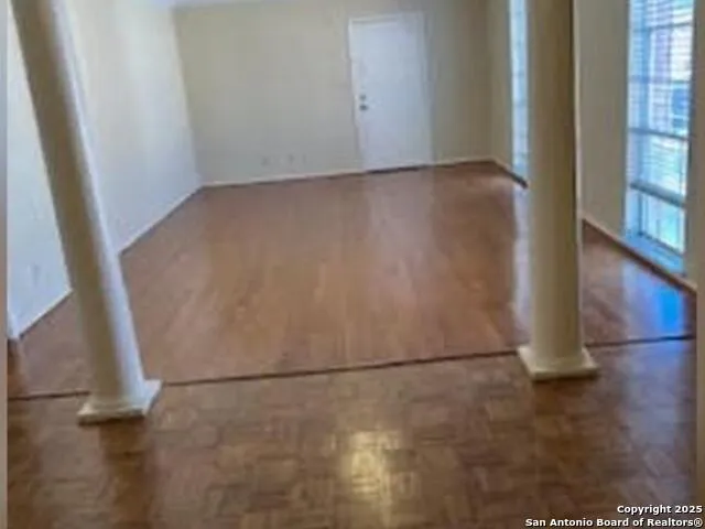 an empty room with wooden floor