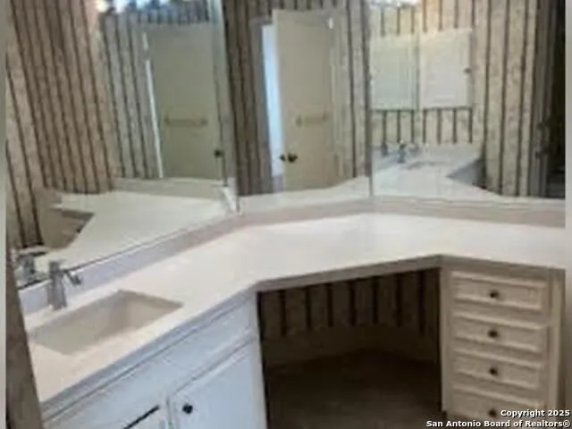 a kitchen with a sink and a mirror