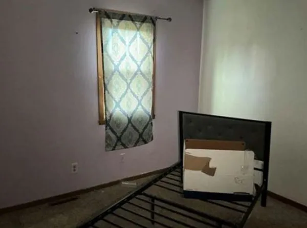 a room with a wooden floor and a window