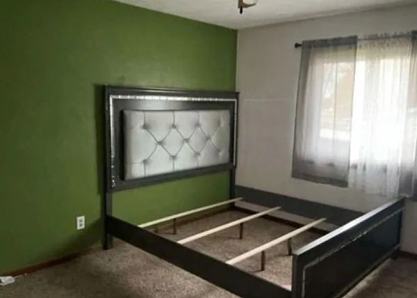 a room with wooden floor and windows