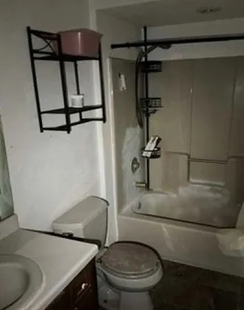a bathroom with a toilet and a shower