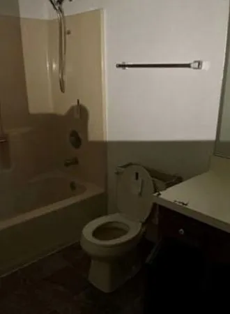 a bathroom with a toilet and a shower