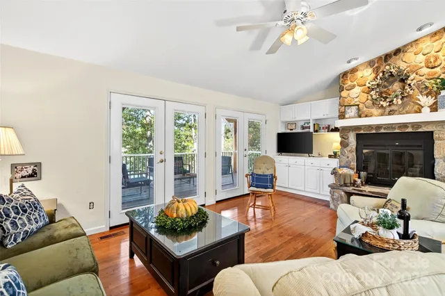 a living room with furniture a flat screen tv and a large window