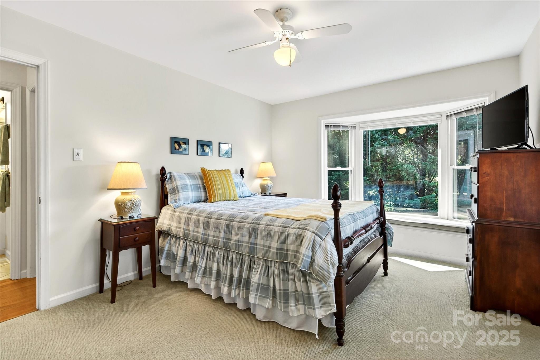 211 Rhododendron Avenue Black Mountain, NC 28711 - Photo 19 of 48 a bedroom with a bed flat screen tv and a large window
