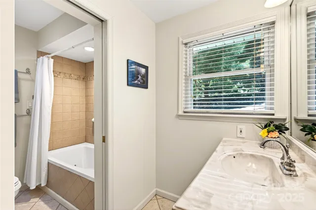 a bathroom with a tub sink and a window
