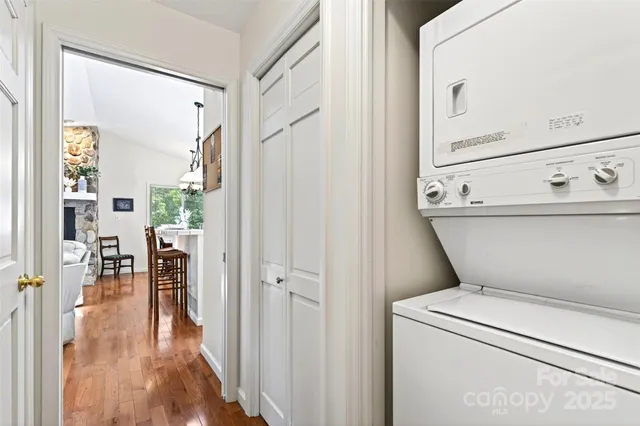 a view of washer and dryer with bathroom in the background