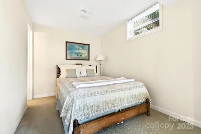 a bedroom with a bed and wall painting