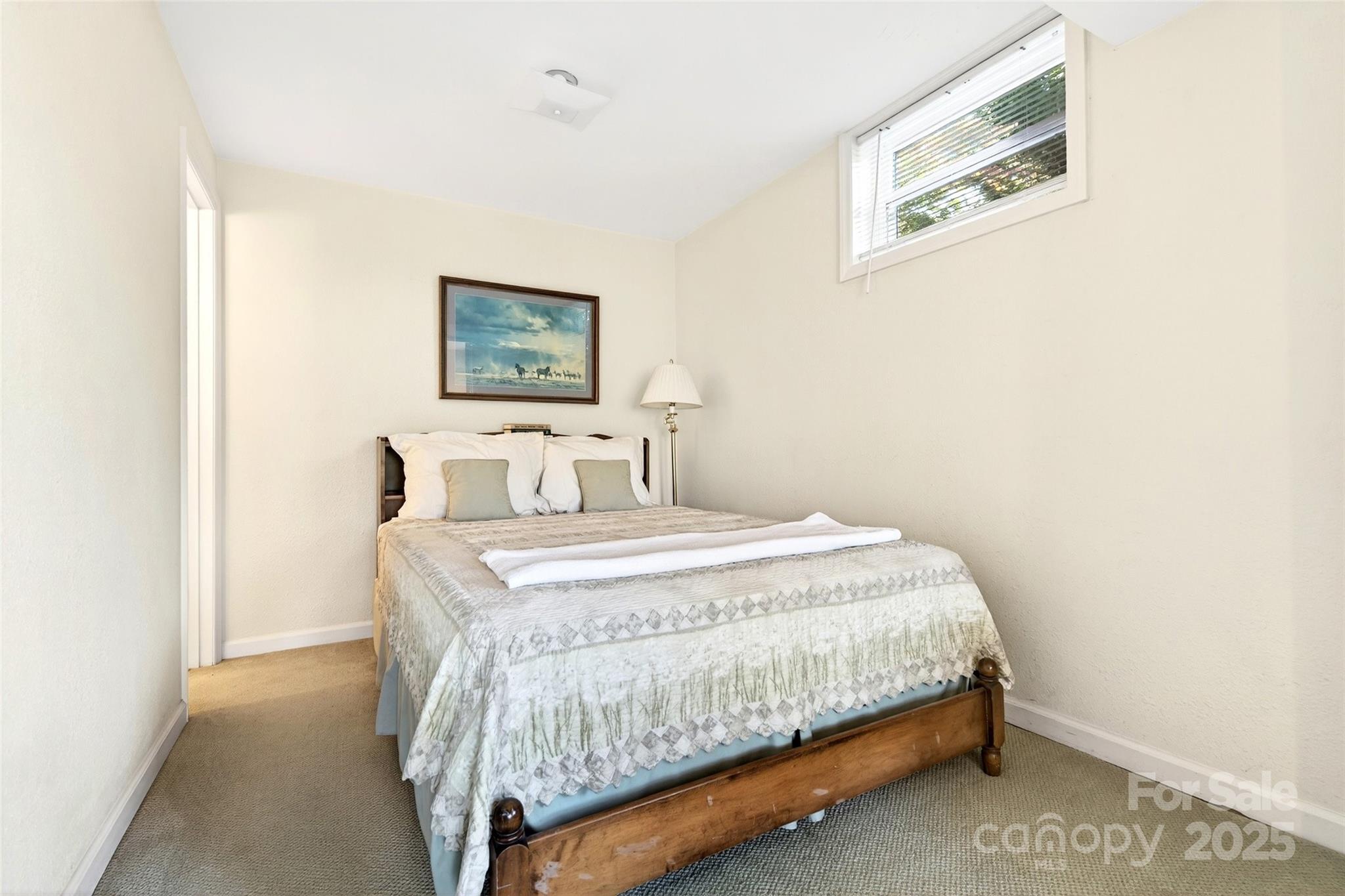 211 Rhododendron Avenue Black Mountain, NC 28711 - Photo 29 of 48 a bedroom with a bed and wall painting