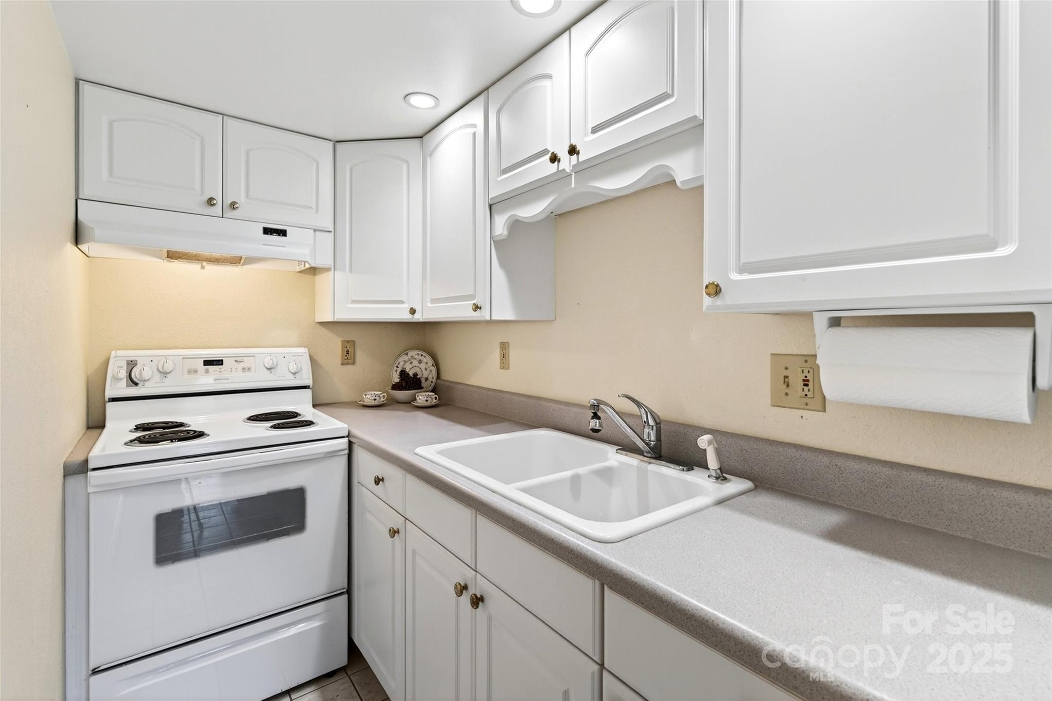211 Rhododendron Avenue Black Mountain, NC 28711 - Photo 32 of 48 a kitchen with cabinets appliances a sink and a window