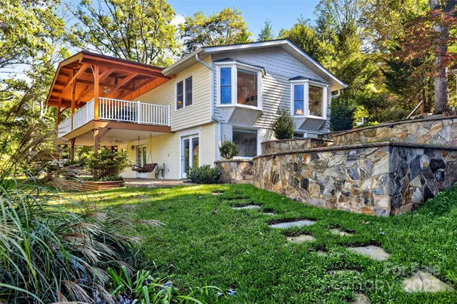 a front view of house with yard and outdoor seating