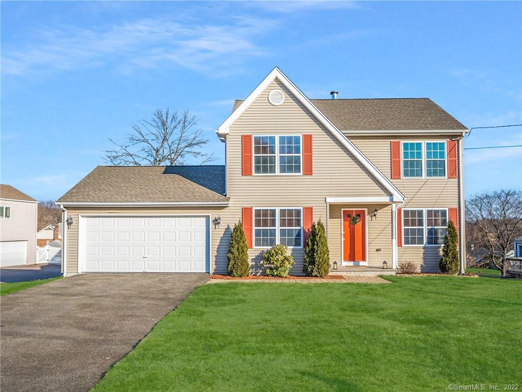 a front view of a house with a yard and porch
