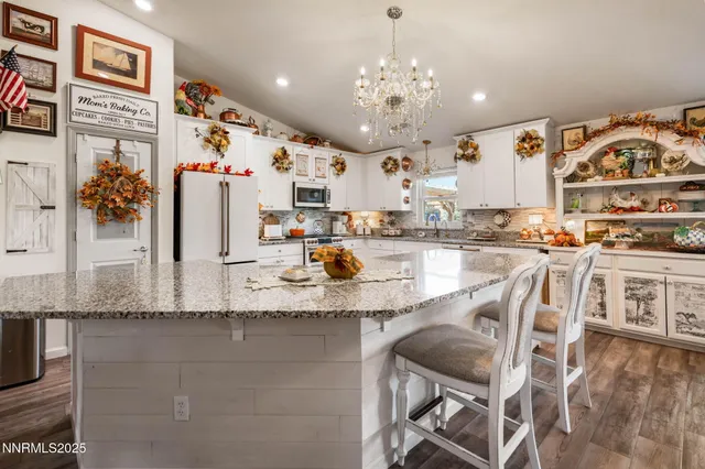 a kitchen with stainless steel appliances granite countertop a sink and cabinets