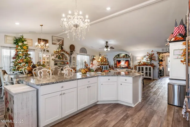 a kitchen with white cabinets and chandelier