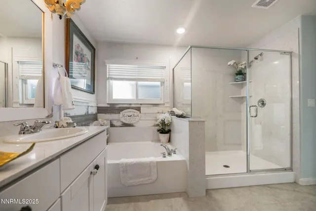 a bathroom with a tub sink shower and mirror