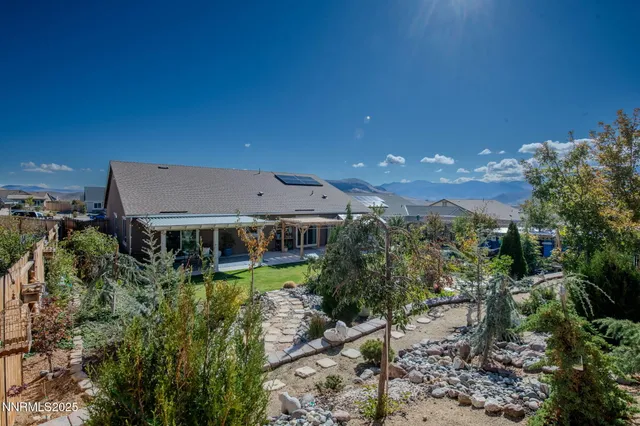 a view of a house with a yard and sitting area