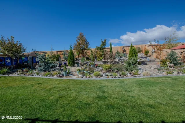 a view of a garden with a building in the background