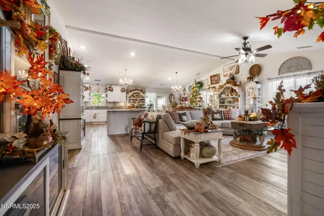 a living room with lots of furniture and a kitchen view