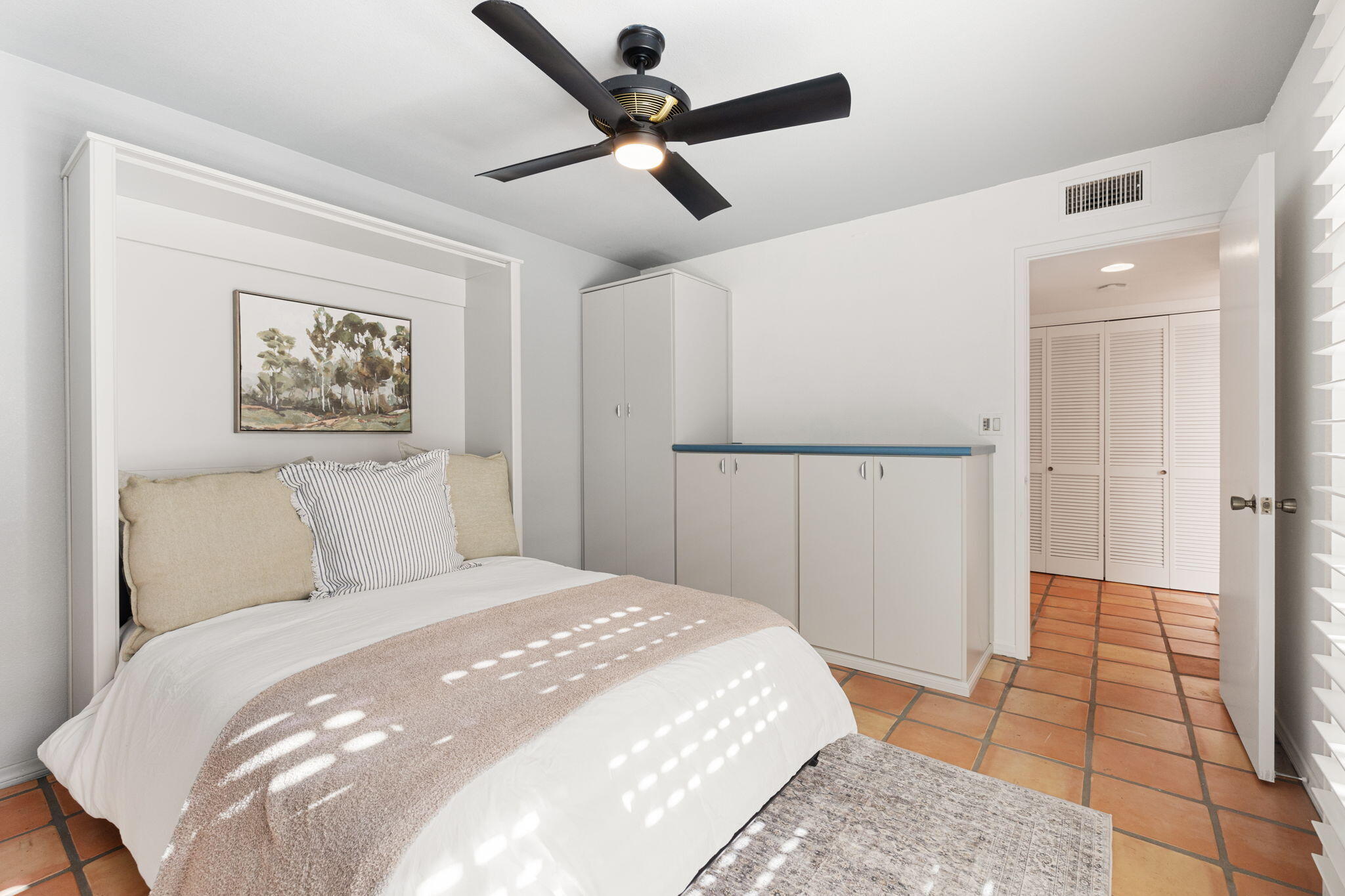 175 Torremolinos Drive Rancho Mirage, CA 92270 - Photo 22 of 60 a bedroom with a large bed and a chandelier