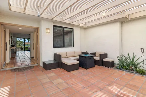 a view of a terrace with seating area and city view