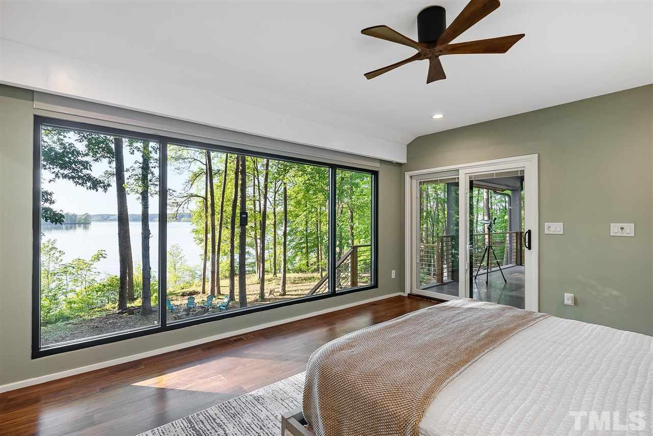 6900 Denlee Road Raleigh, NC 27603 - Photo 14 of 30 a bedroom with a large bed and a large window