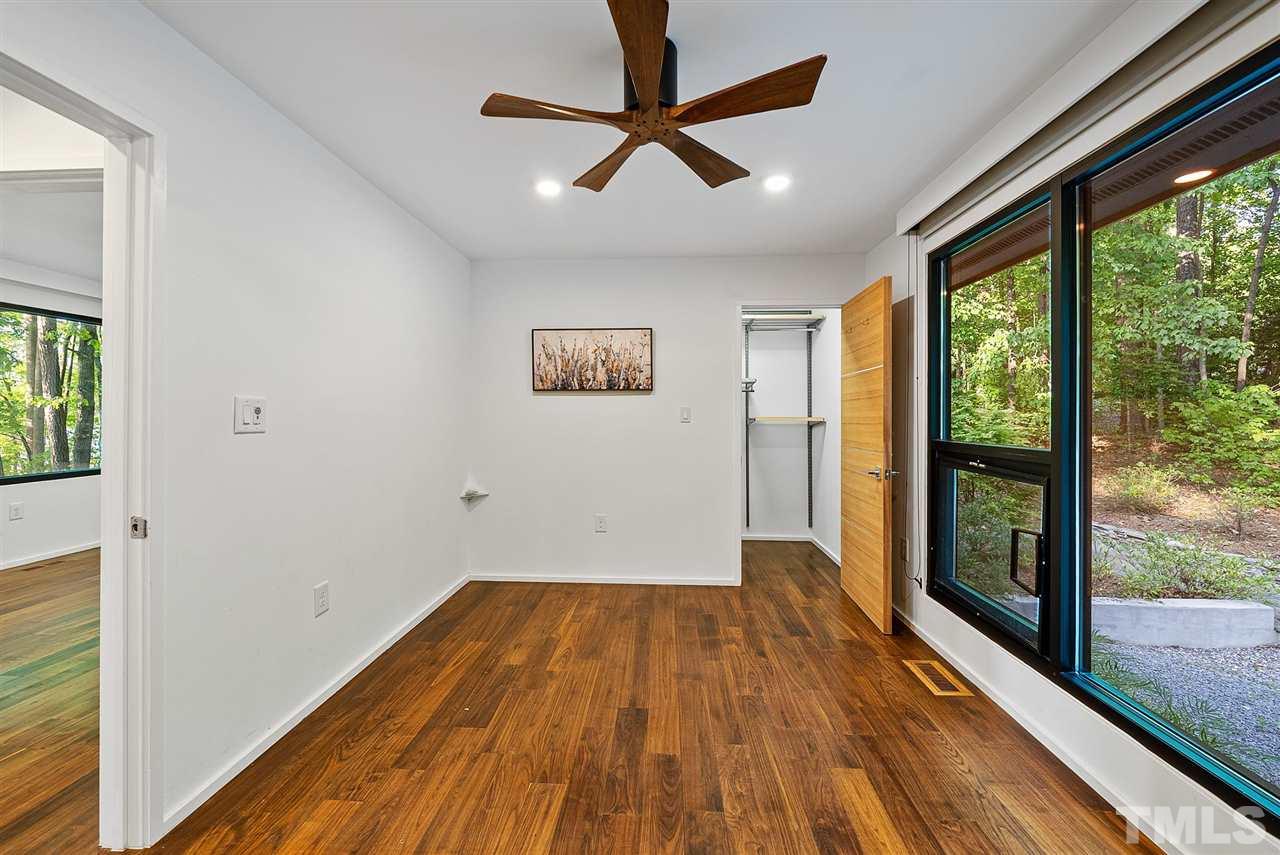 6900 Denlee Road Raleigh, NC 27603 - Photo 20 of 30 a view of empty room with wooden floor and fan