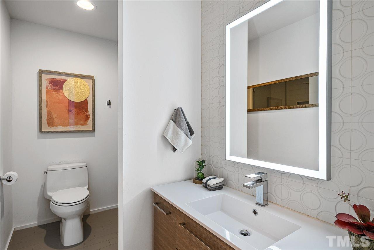 6900 Denlee Road Raleigh, NC 27603 - Photo 21 of 30 a bathroom with a toilet sink and mirror
