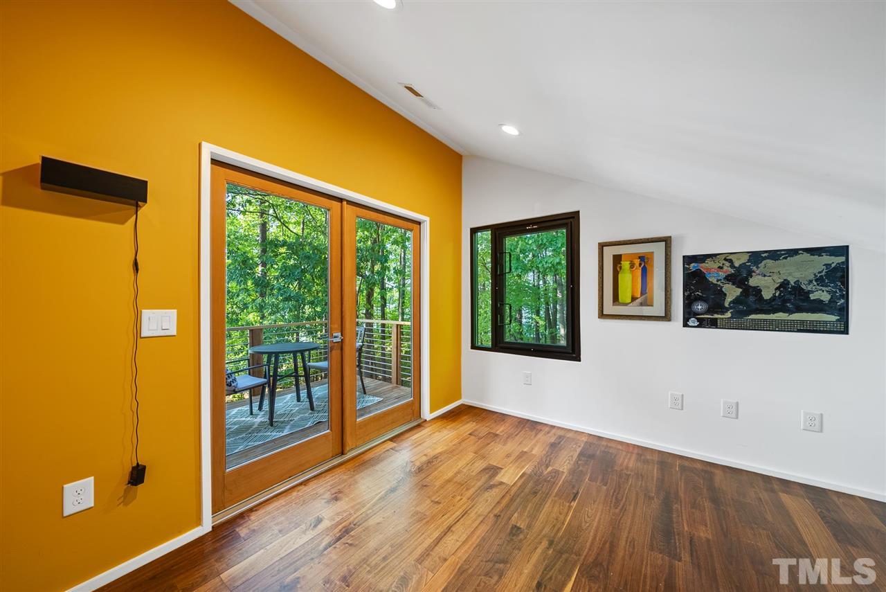 6900 Denlee Road Raleigh, NC 27603 - Photo 22 of 30 a view of an empty room with wooden floor and a window