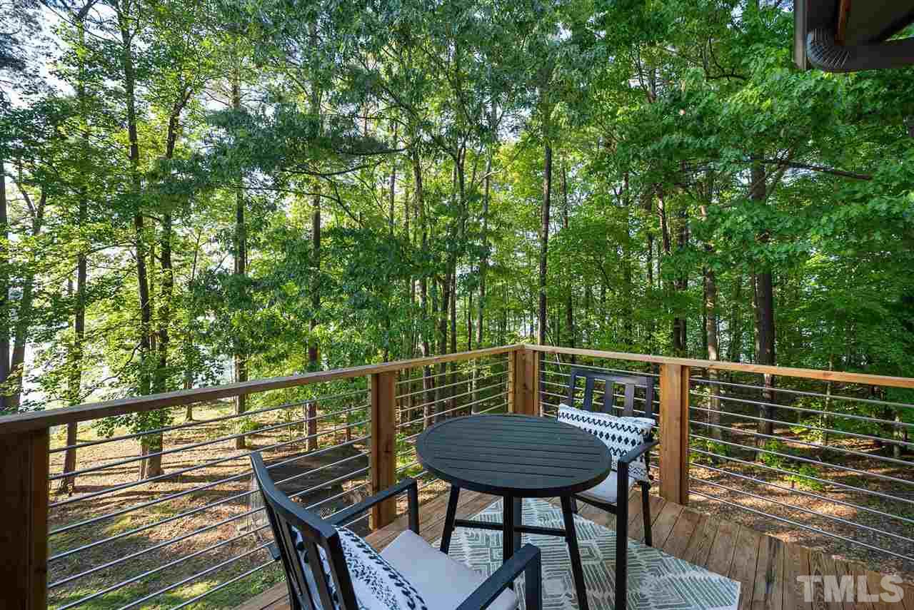6900 Denlee Road Raleigh, NC 27603 - Photo 23 of 30 a view of a chairs and table on the wooden deck