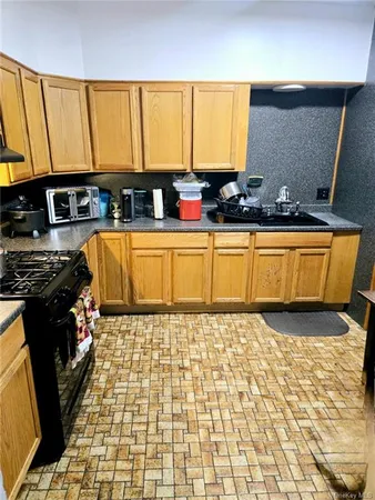 a bathroom with a granite countertop sink and a black white cabinets