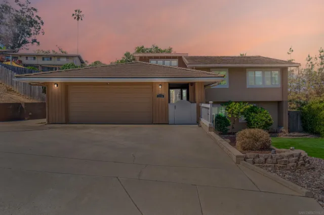 a view of a house with a yard and plants