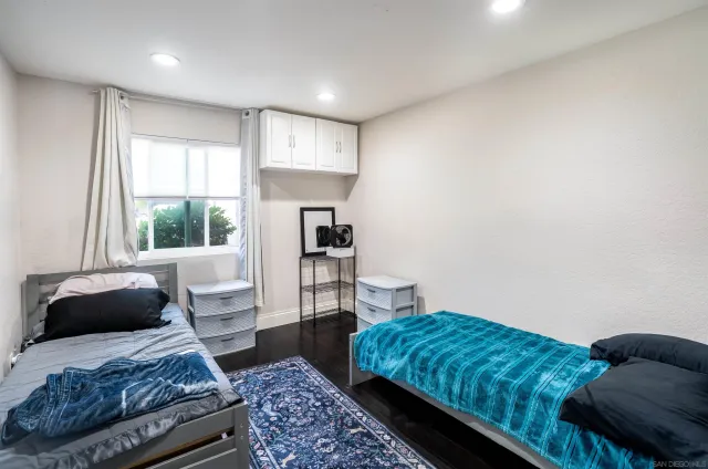 a bedroom with a bed couch and window