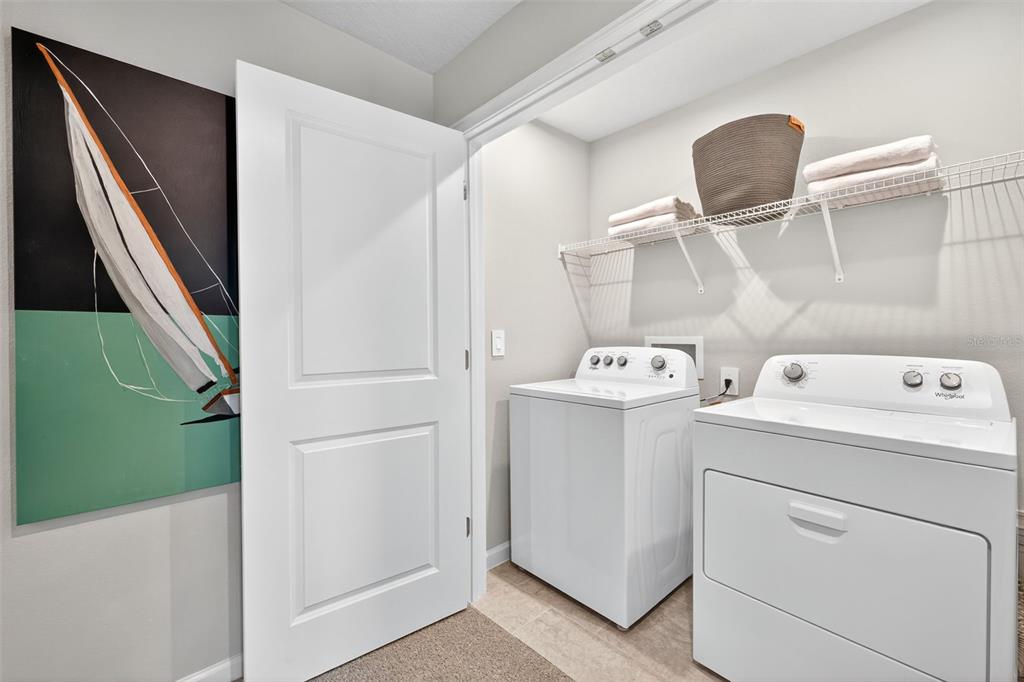 8838 Ginko Run Parrish, FL 34219 - Photo 17 of 21 a view of bathroom with a washer and dryer
